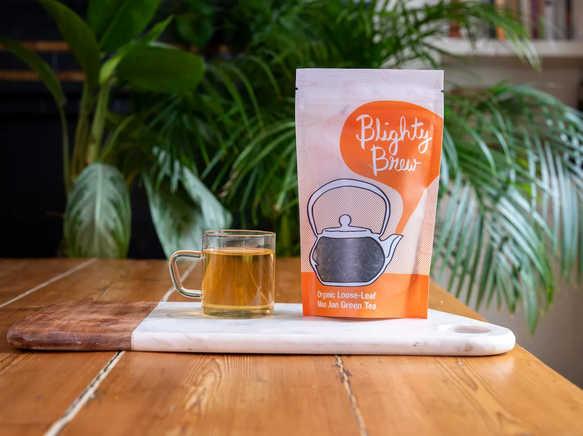Photo of Blighty Booch loose-leaf tea packaging and a cup of tea