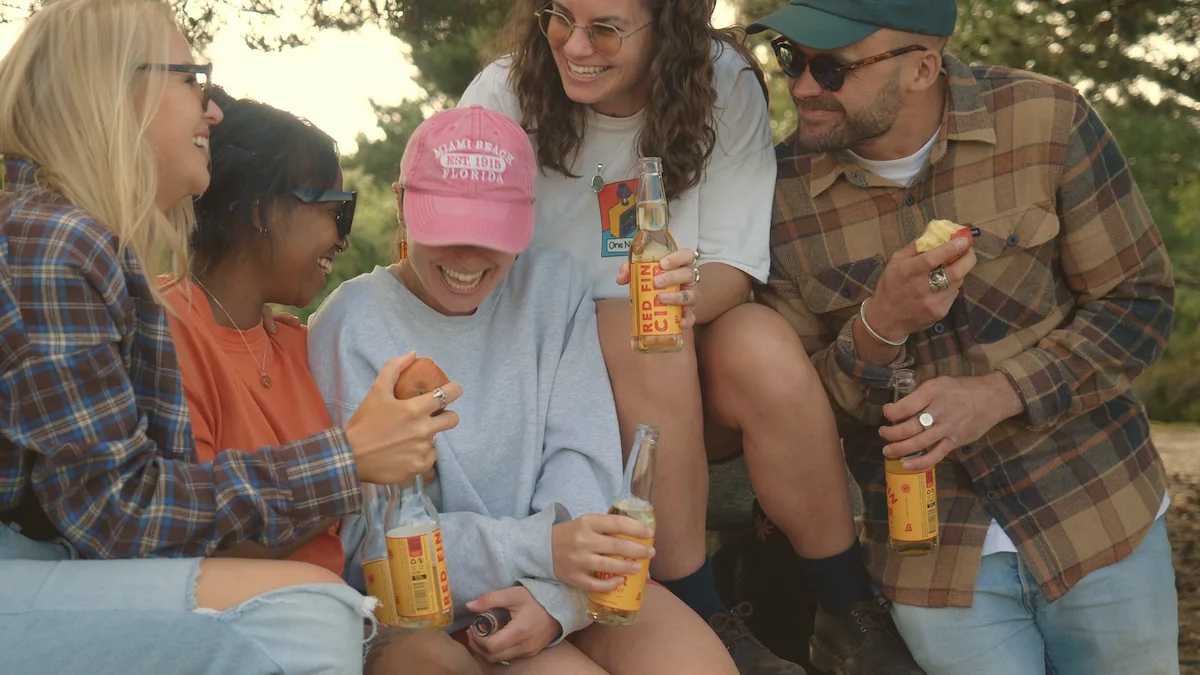Photo of a group of people smiling and drinking Red Fin Cider
